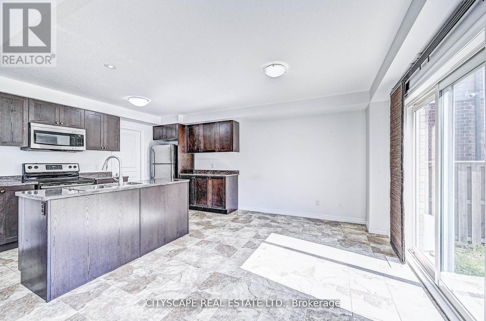 A kitchen with a stove top oven and a microwave.
