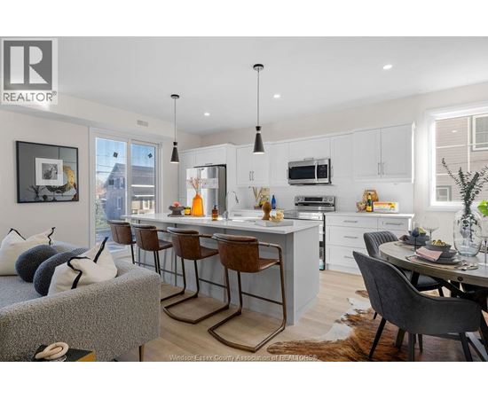 A modern kitchen with a dining table and chairs.