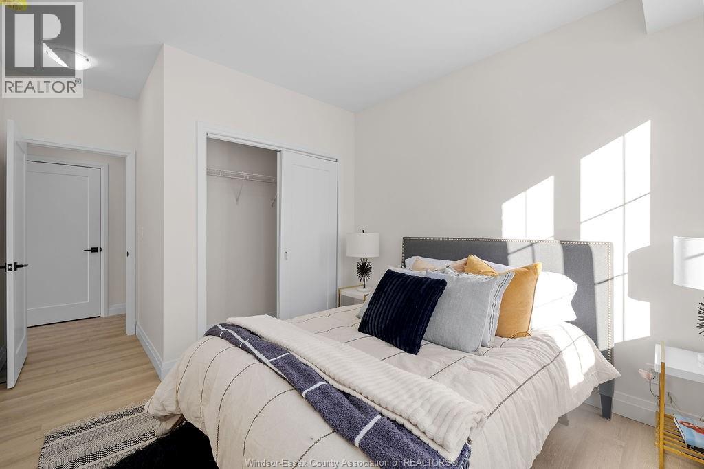 A bedroom with a bed, pillows, and a blanket.