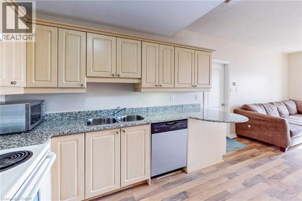A kitchen with wooden cabinets and a granite countertop.