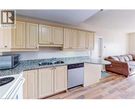 A kitchen with wooden cabinets and a granite countertop.