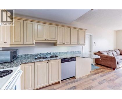 A kitchen with wooden cabinets and a granite countertop.