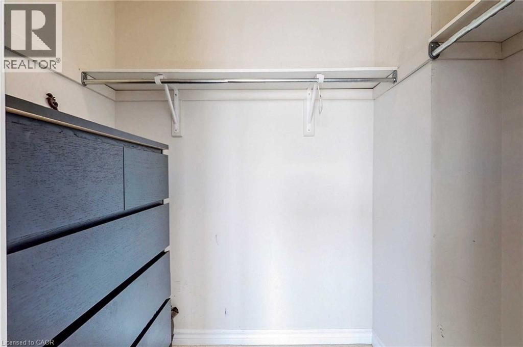 A bedroom with a bed and a cabinet.