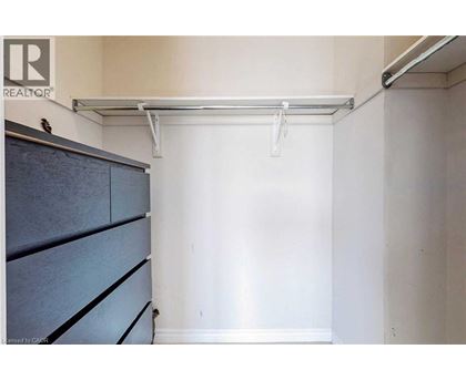 A bedroom with a bed and a cabinet.
