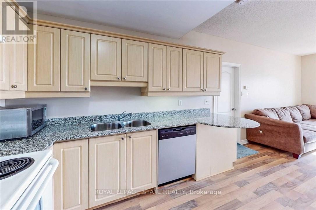 A kitchen with wooden cabinets and a granite countertop.