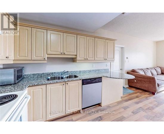 A kitchen with wooden cabinets and a granite countertop.