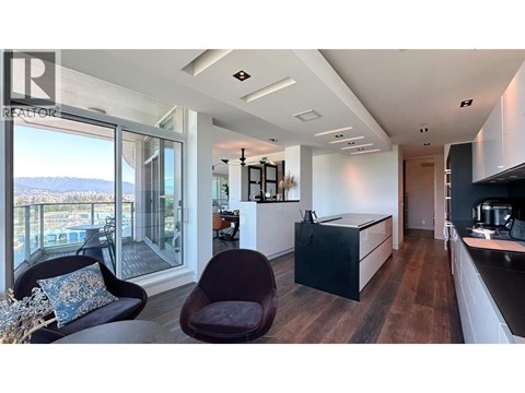A modern kitchen with a view of the mountains.