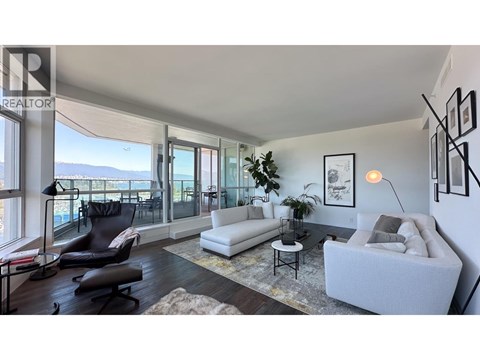 A living room with a white couch and a black chair.