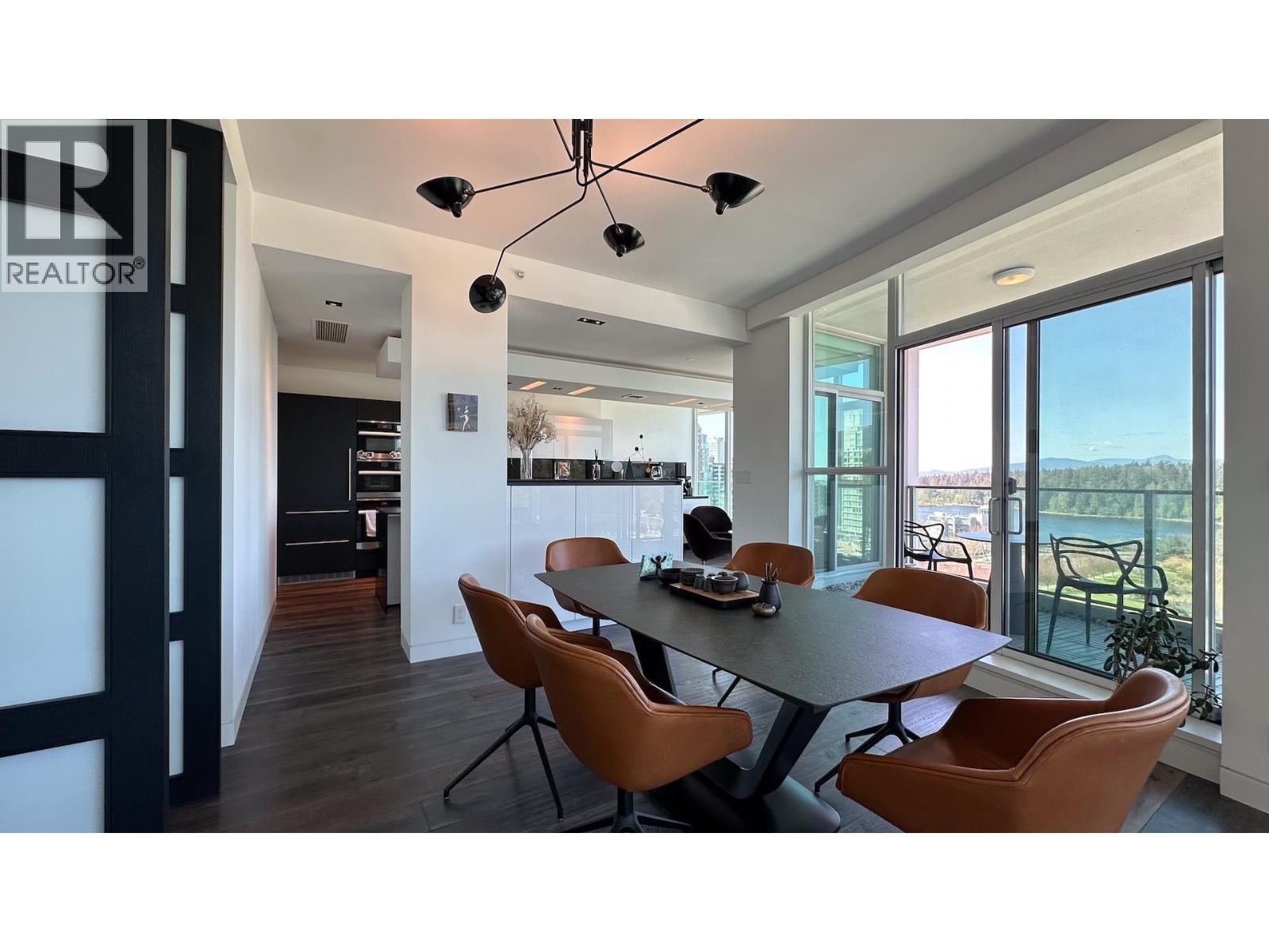 A modern dining room with a table set for four.
