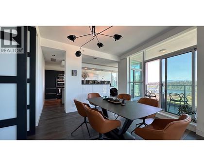 A modern dining room with a table set for four.