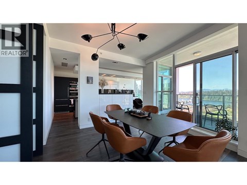 A modern dining room with a table set for four.