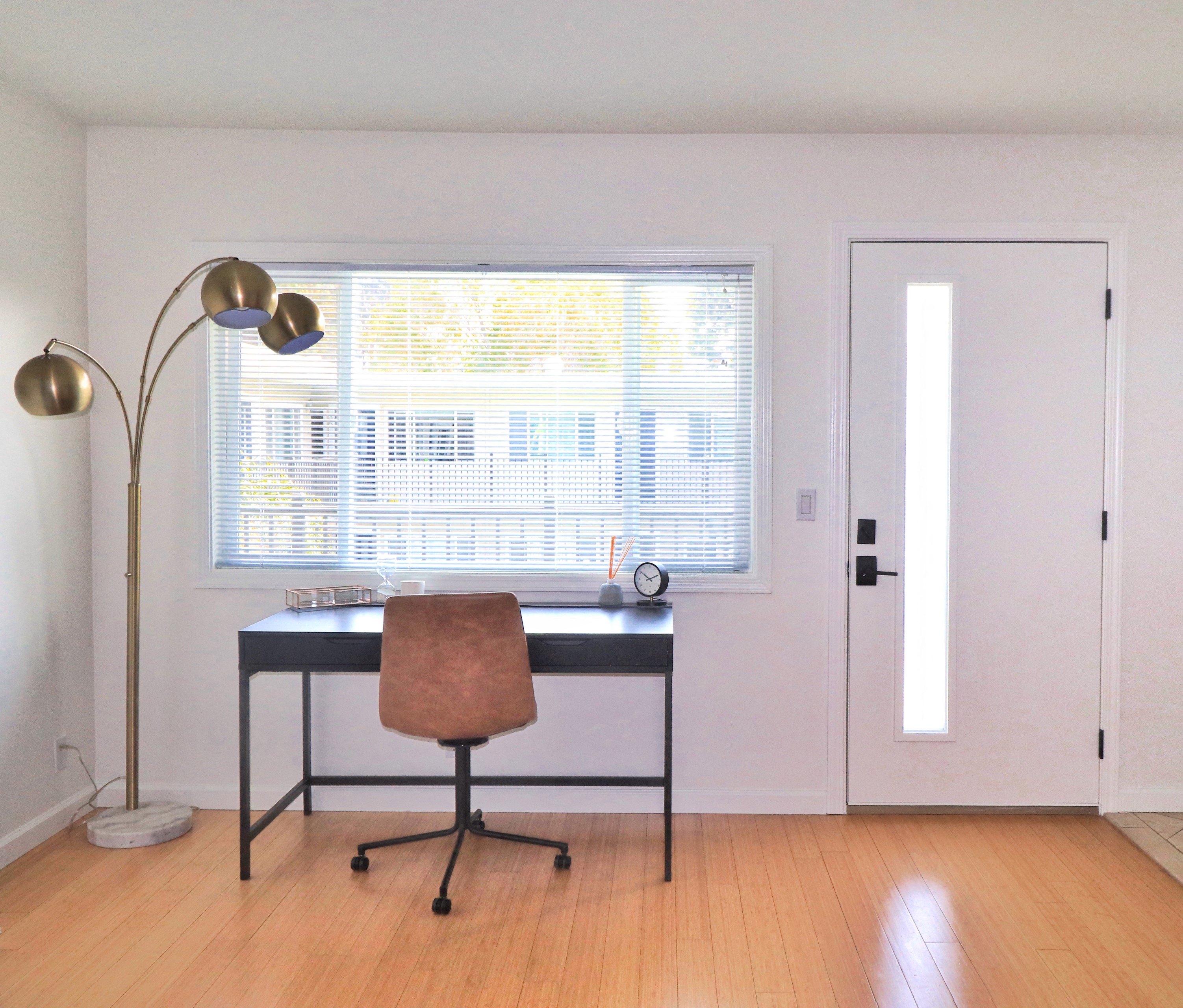 an empty room with a desk and a chair and a window