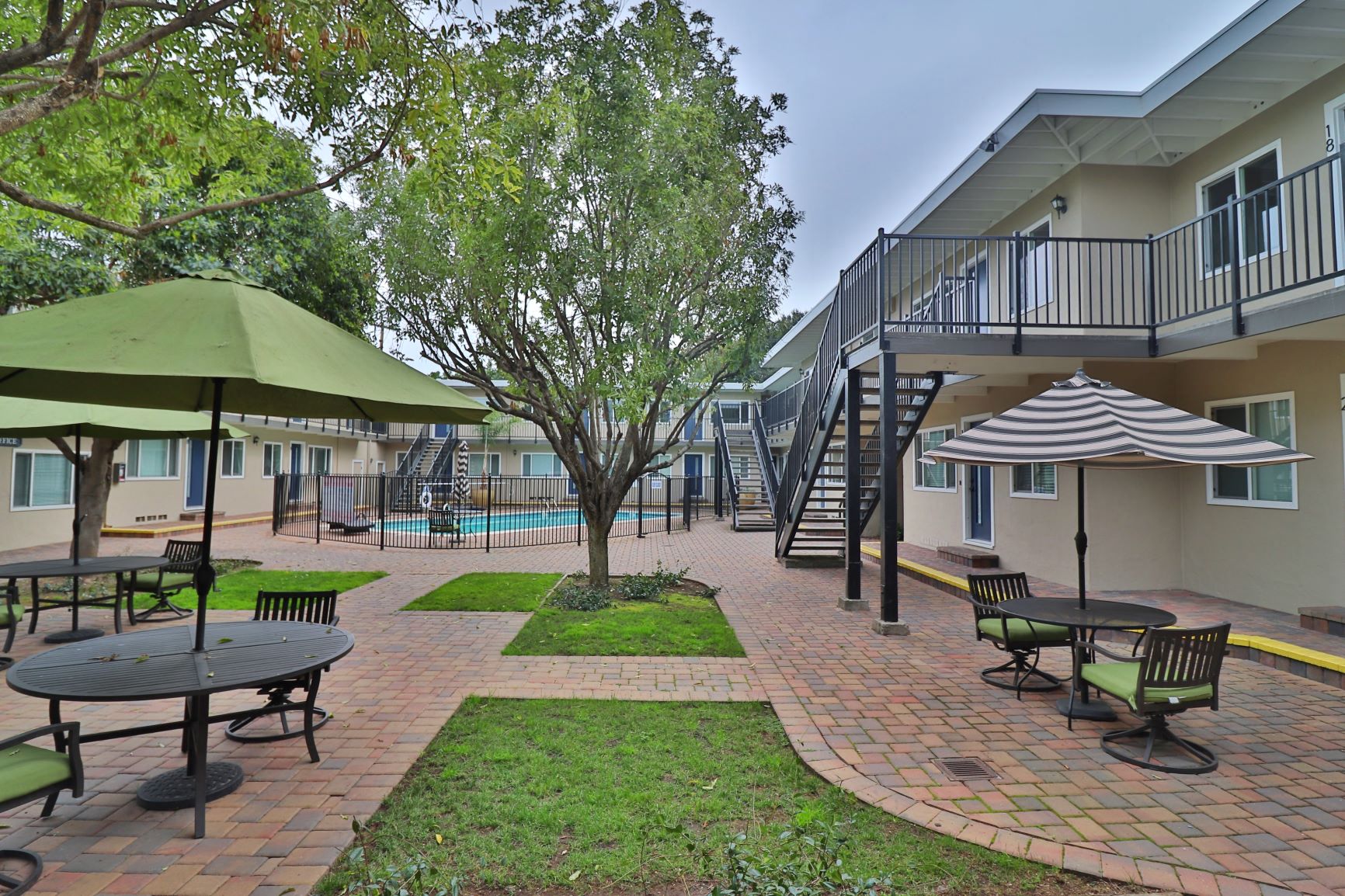 our apartments have a patio with tables and umbrellas