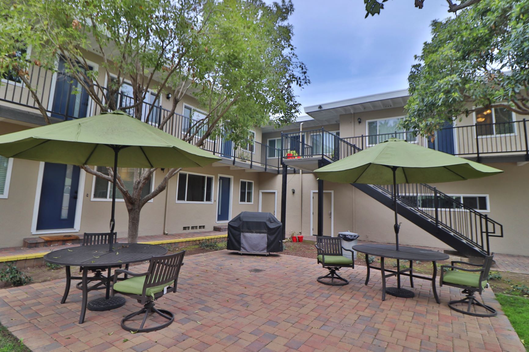 our apartments have a patio with tables and umbrellas