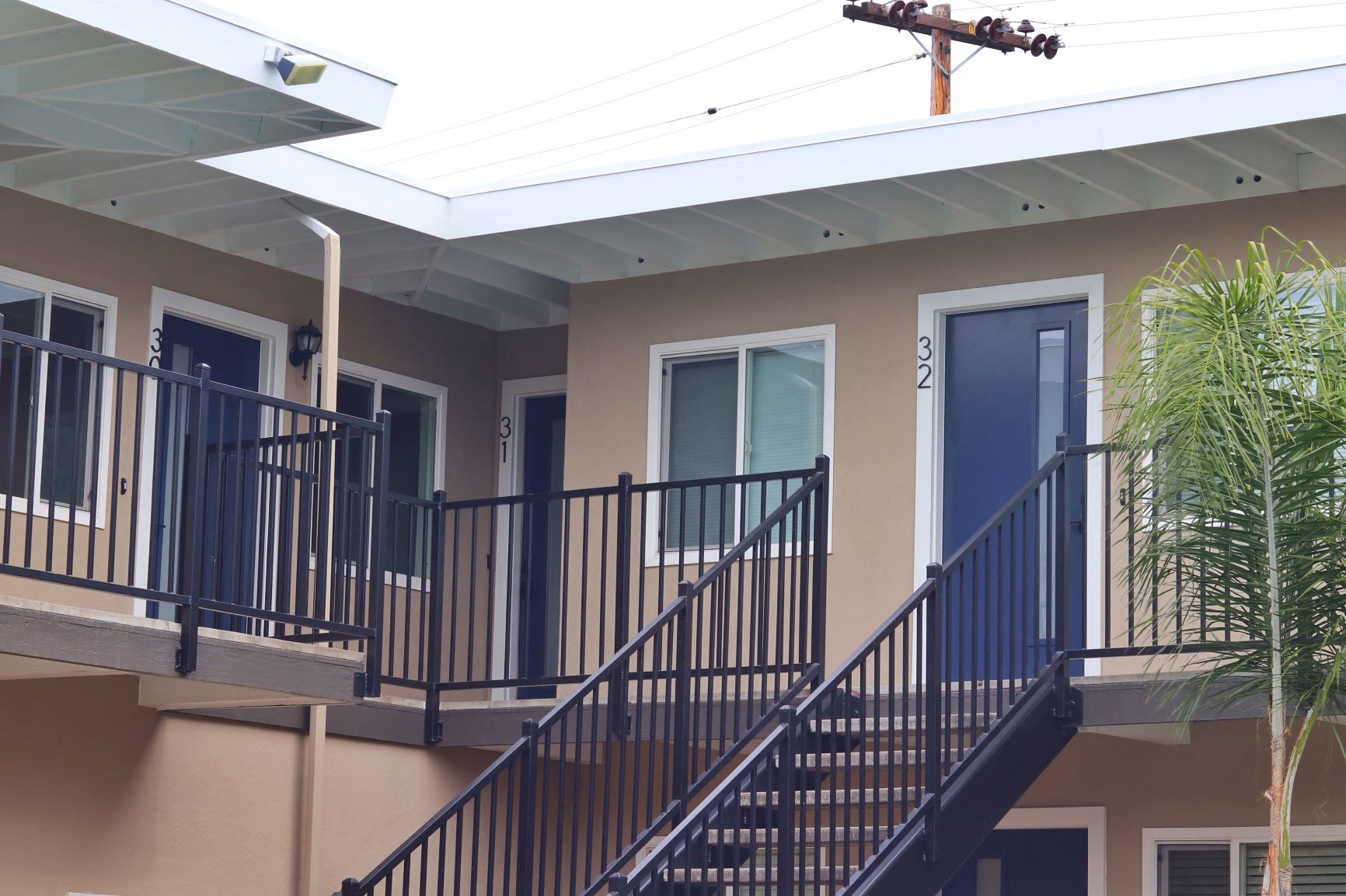 a building with stairs and a cross on the roof
