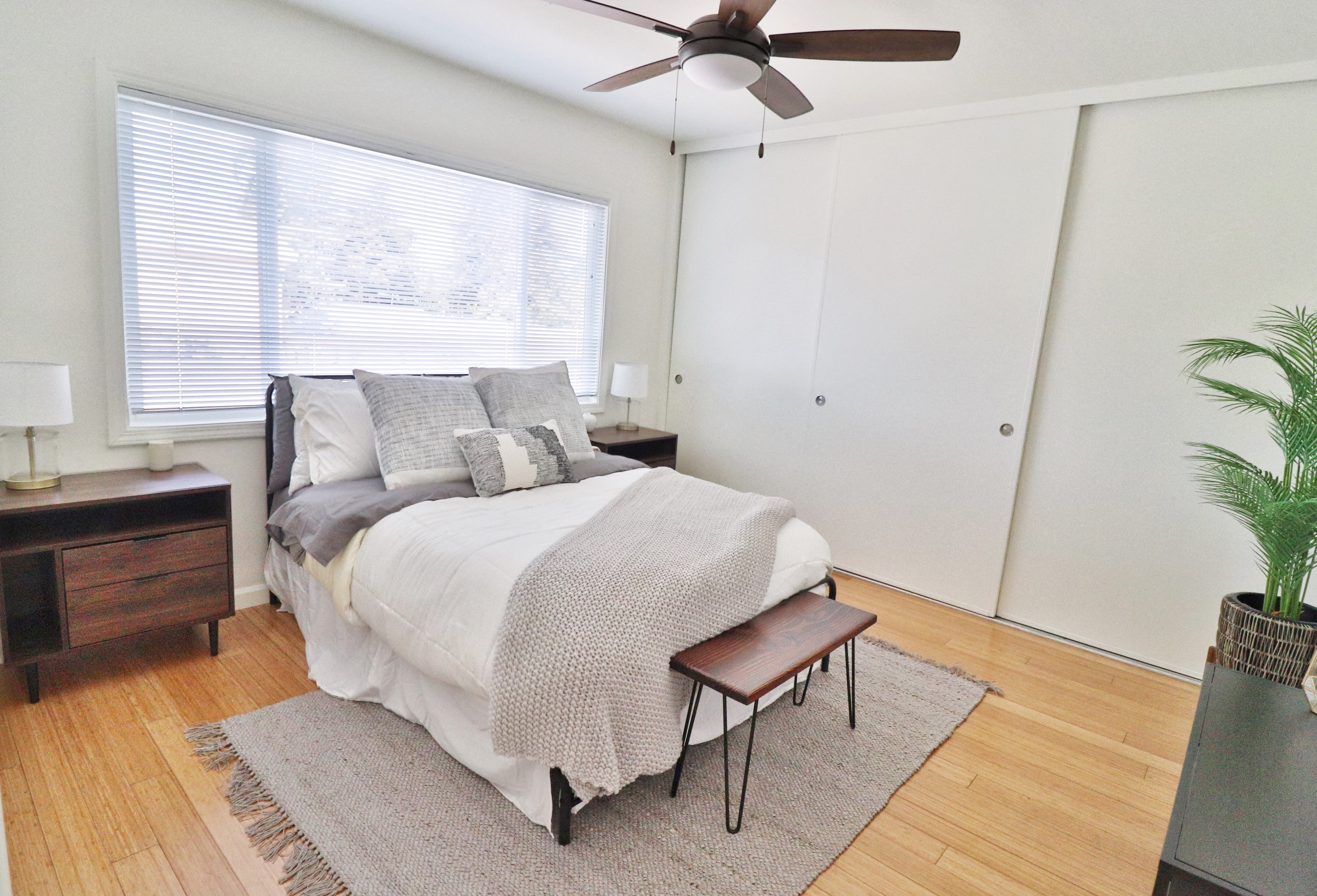 a bedroom with a bed and a ceiling fan