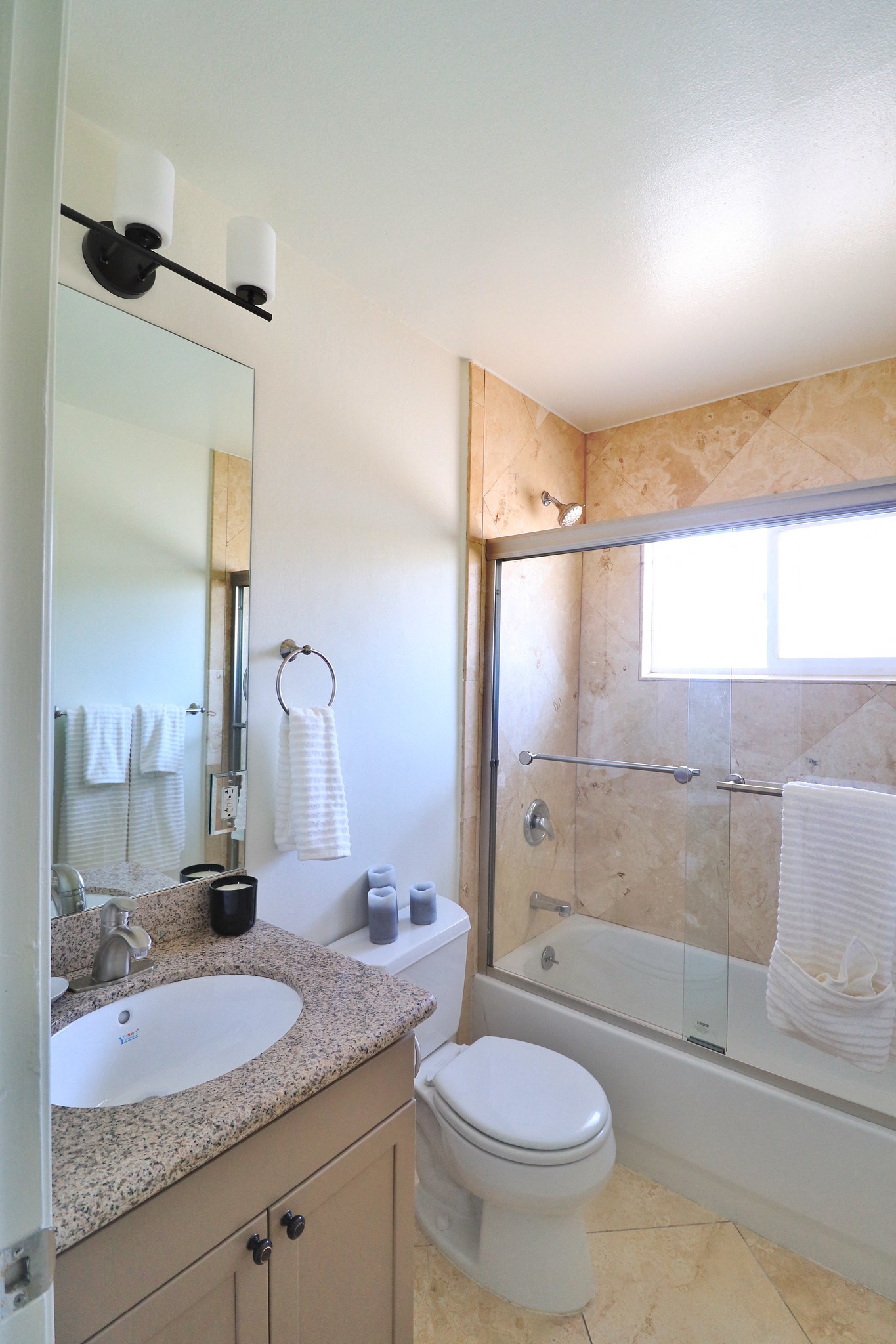 a bathroom with a shower toilet and sink