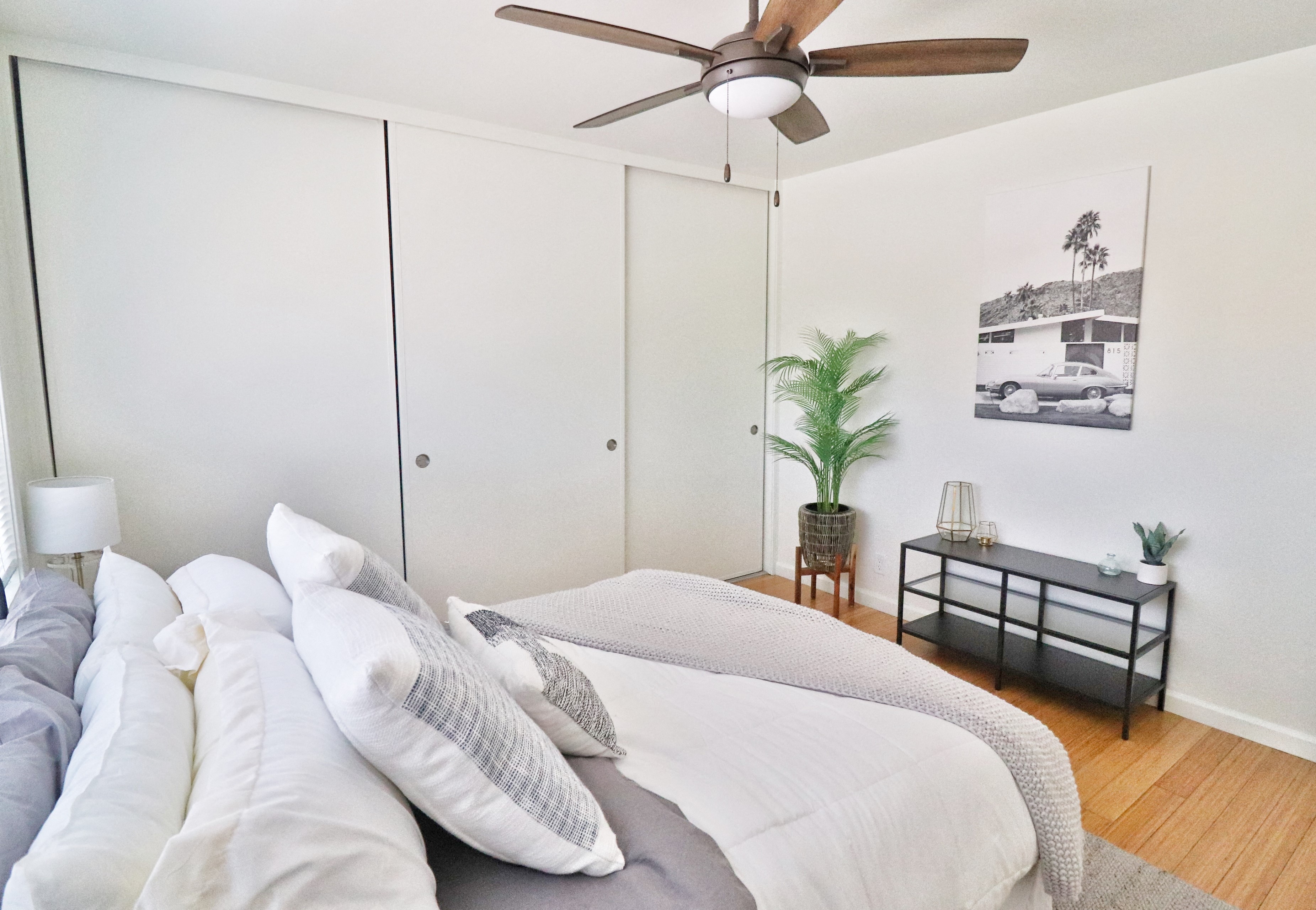 a bedroom with a large bed and a ceiling fan