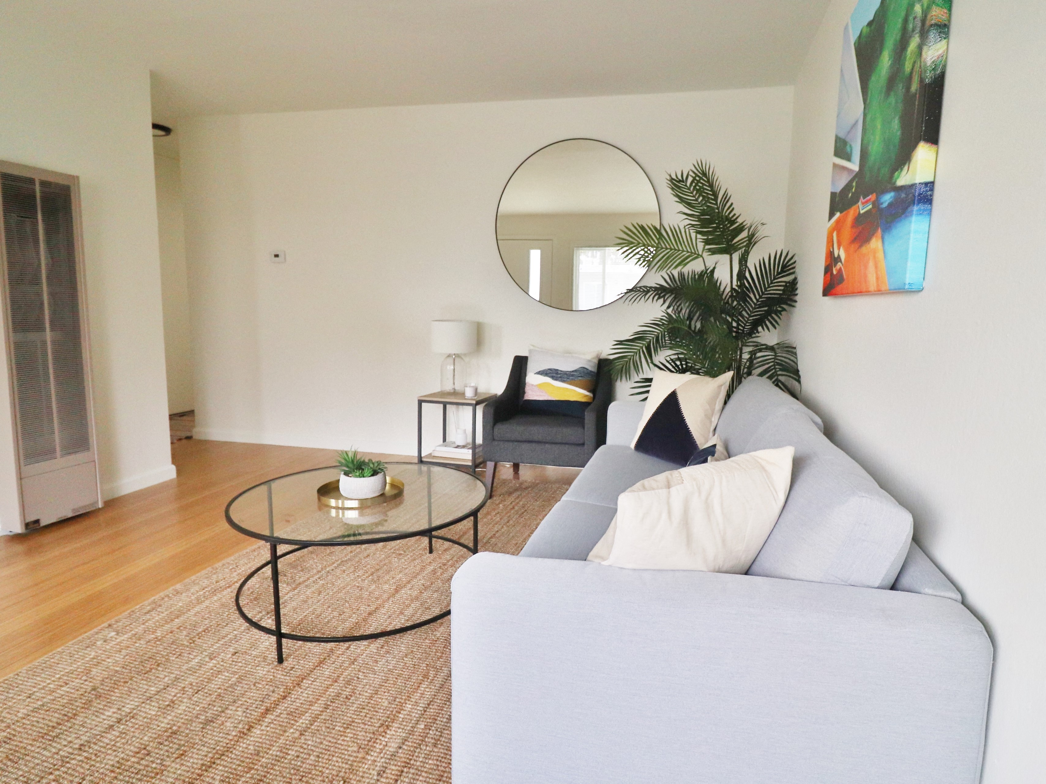 a living room with a couch and a round coffee table