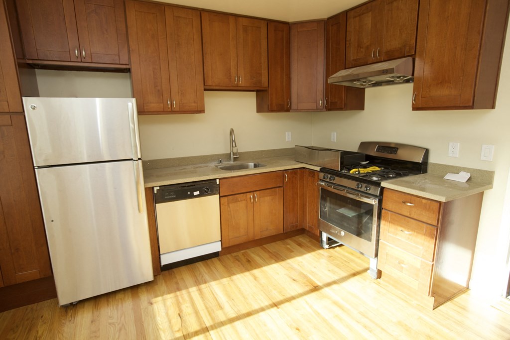 a kitchen with wooden cabinets and stainless steel appliances