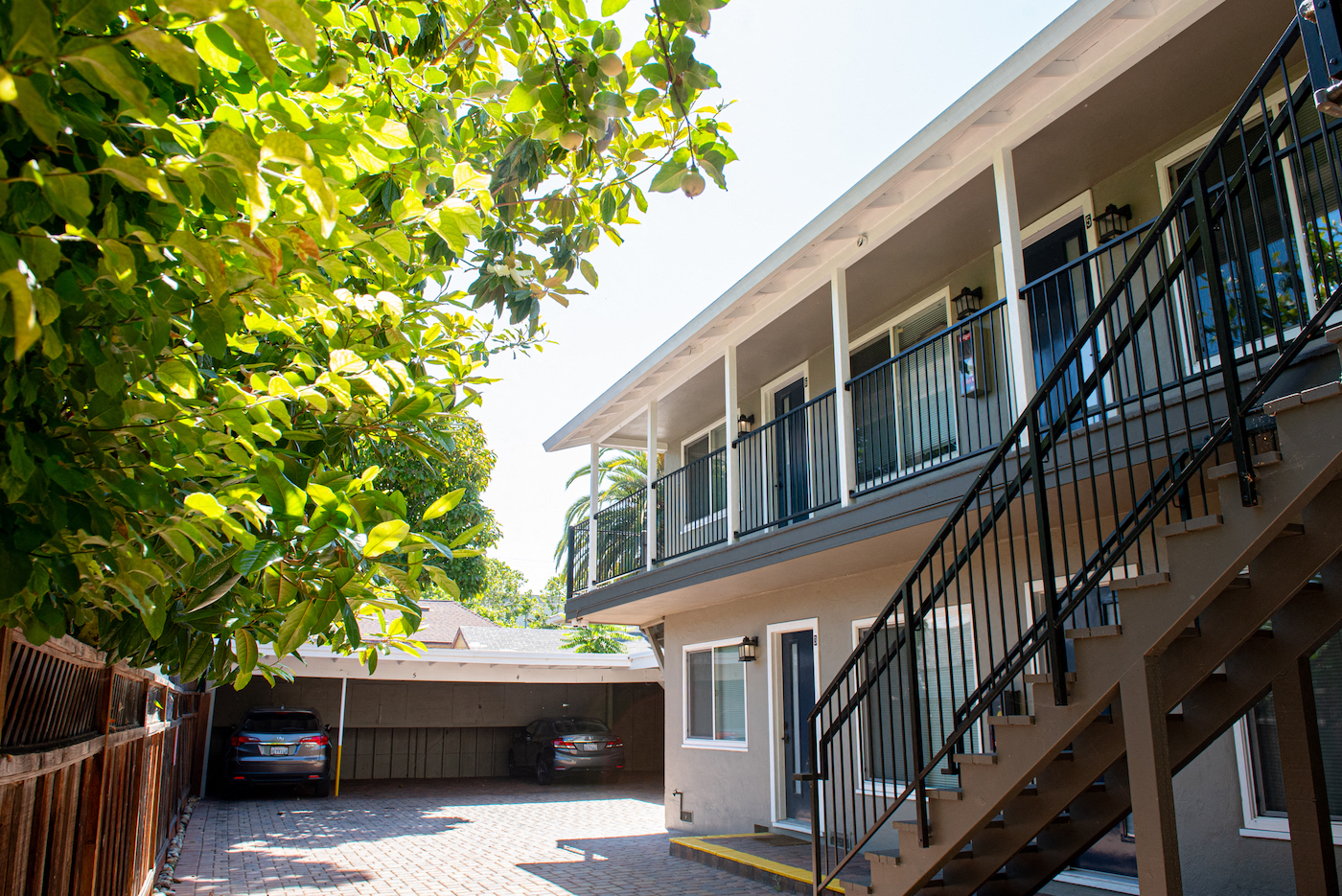 the exterior of a building with stairs and a parking lot