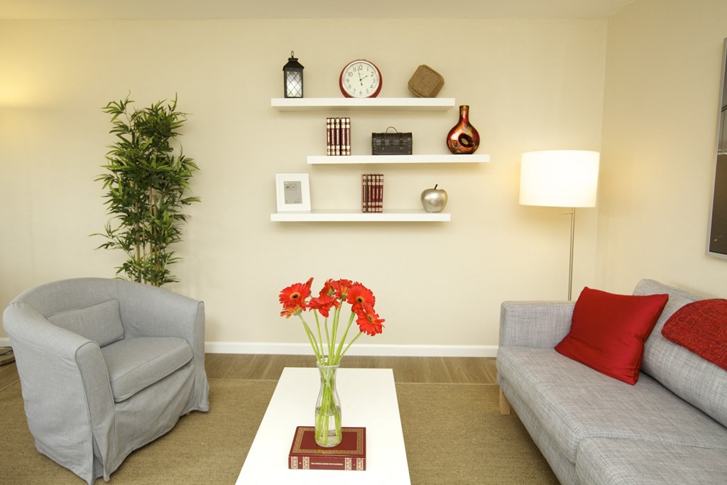 a living room with two couches and a table with flowers
