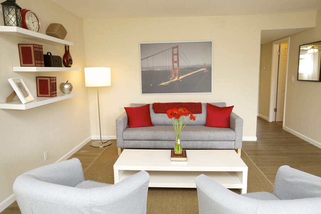 a living room with a couch and a table with flowers