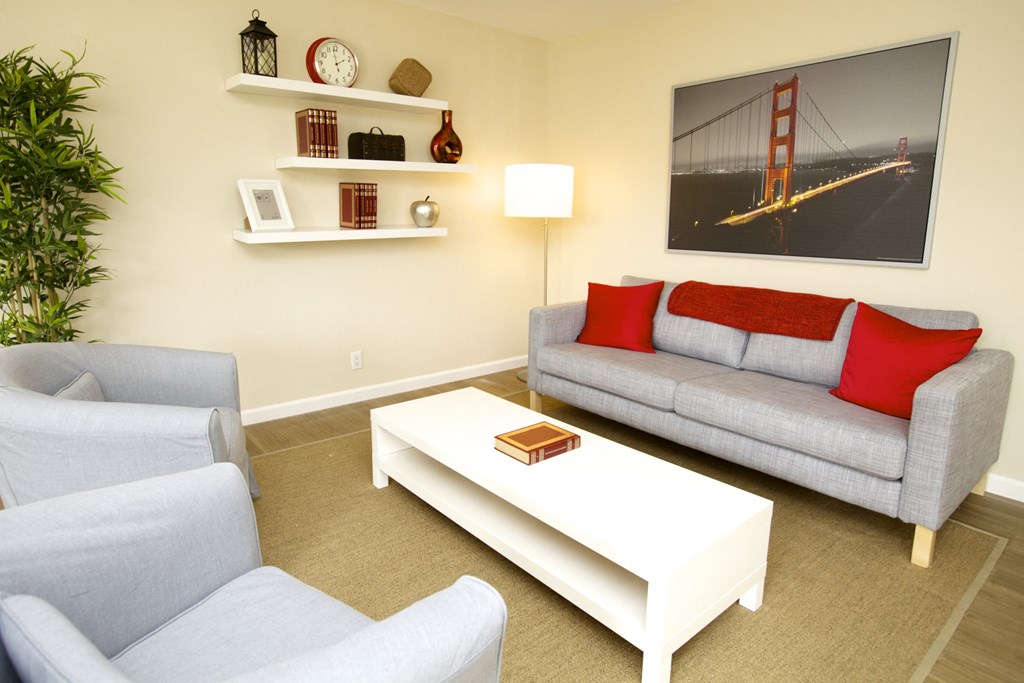 a living room with a couch and two chairs and a coffee table