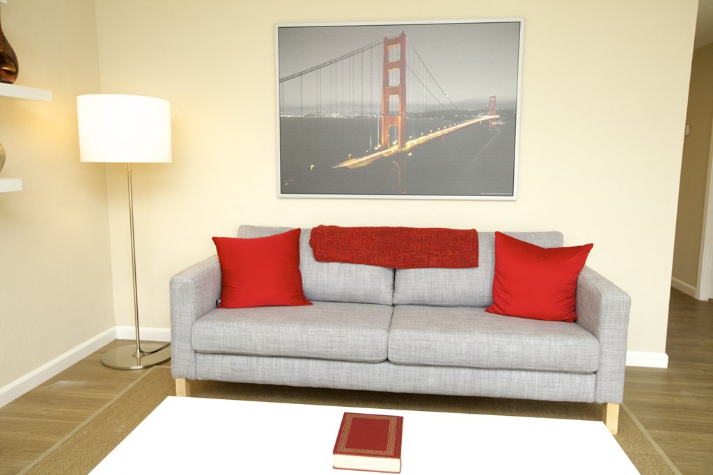 a living room with a couch and a picture of the golden gate bridge