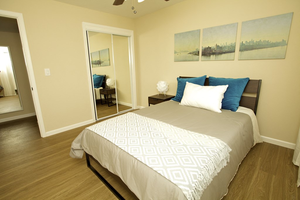 a bedroom with a large bed and a mirror