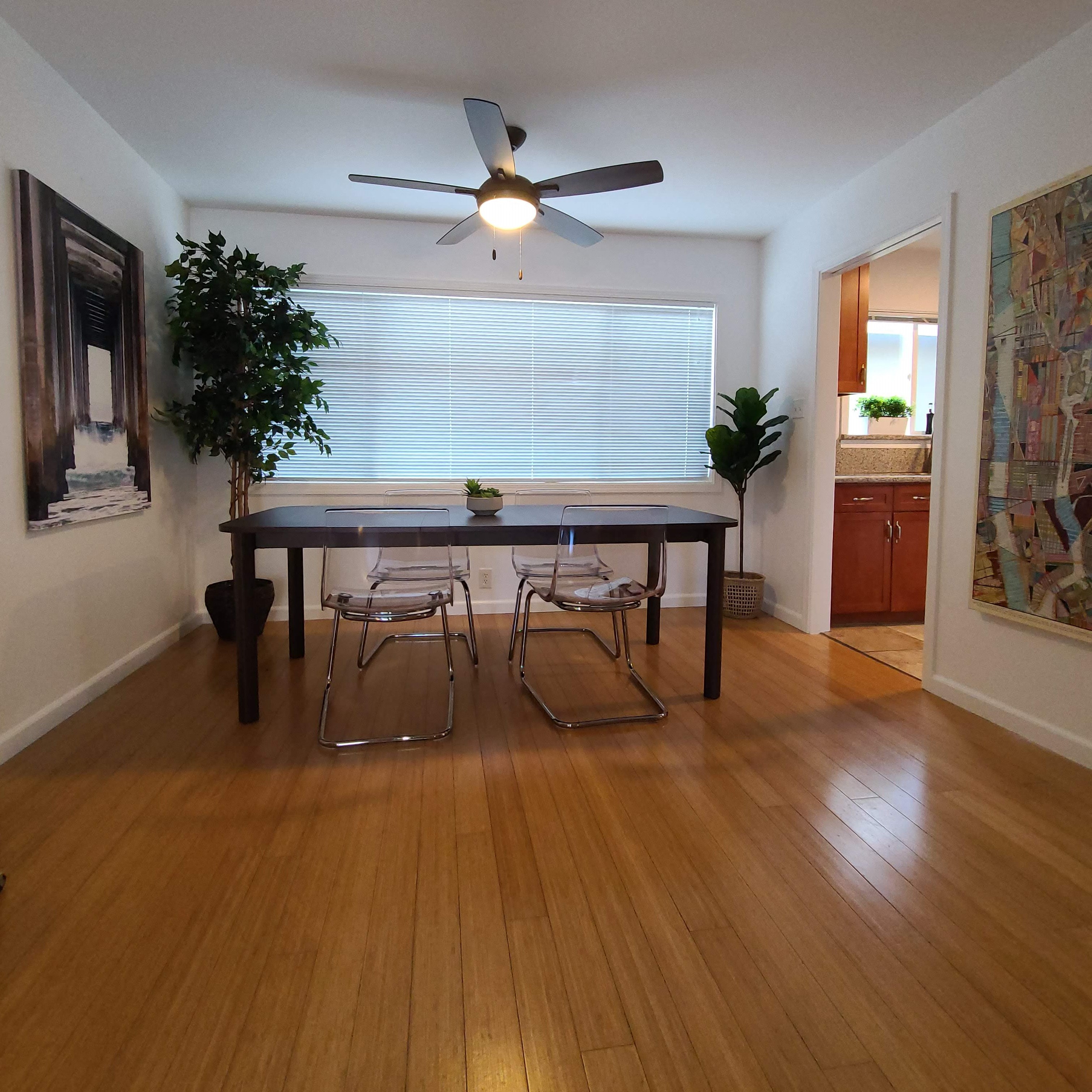 a dining room with a table and a ceiling fan