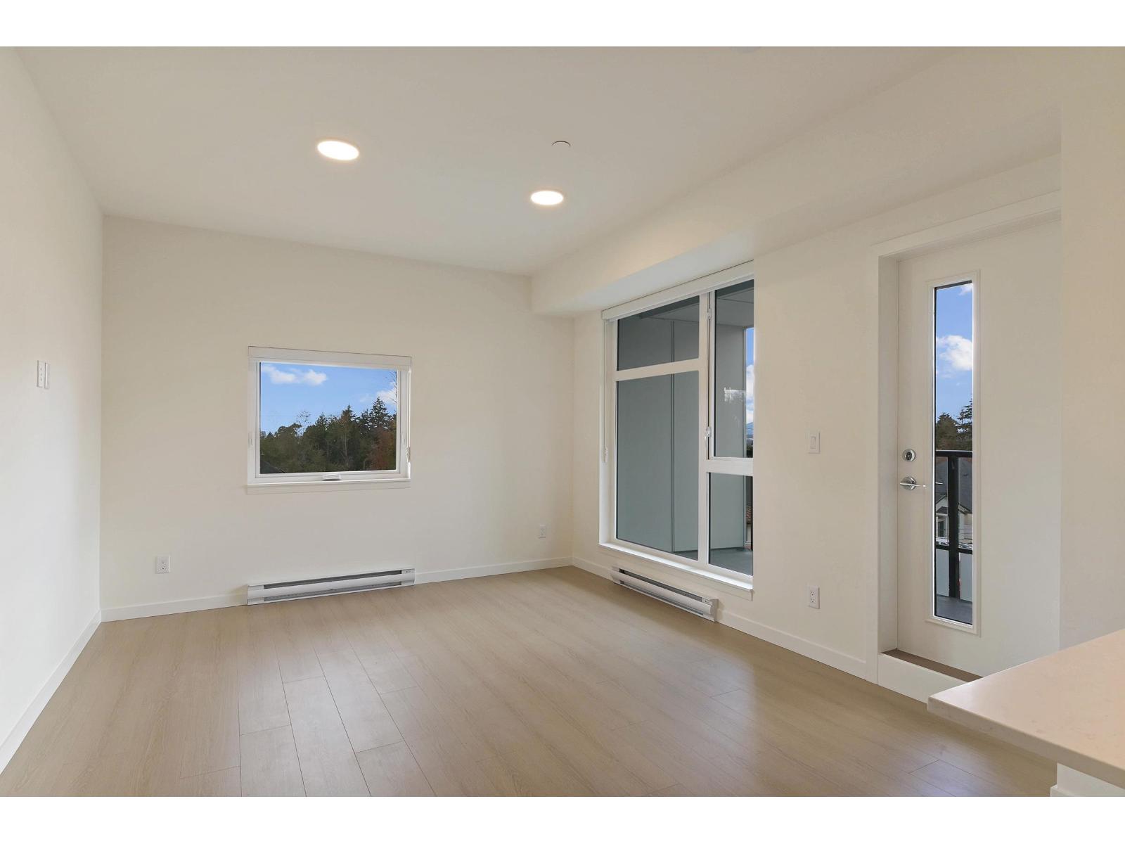 A spacious room with a window and a door.