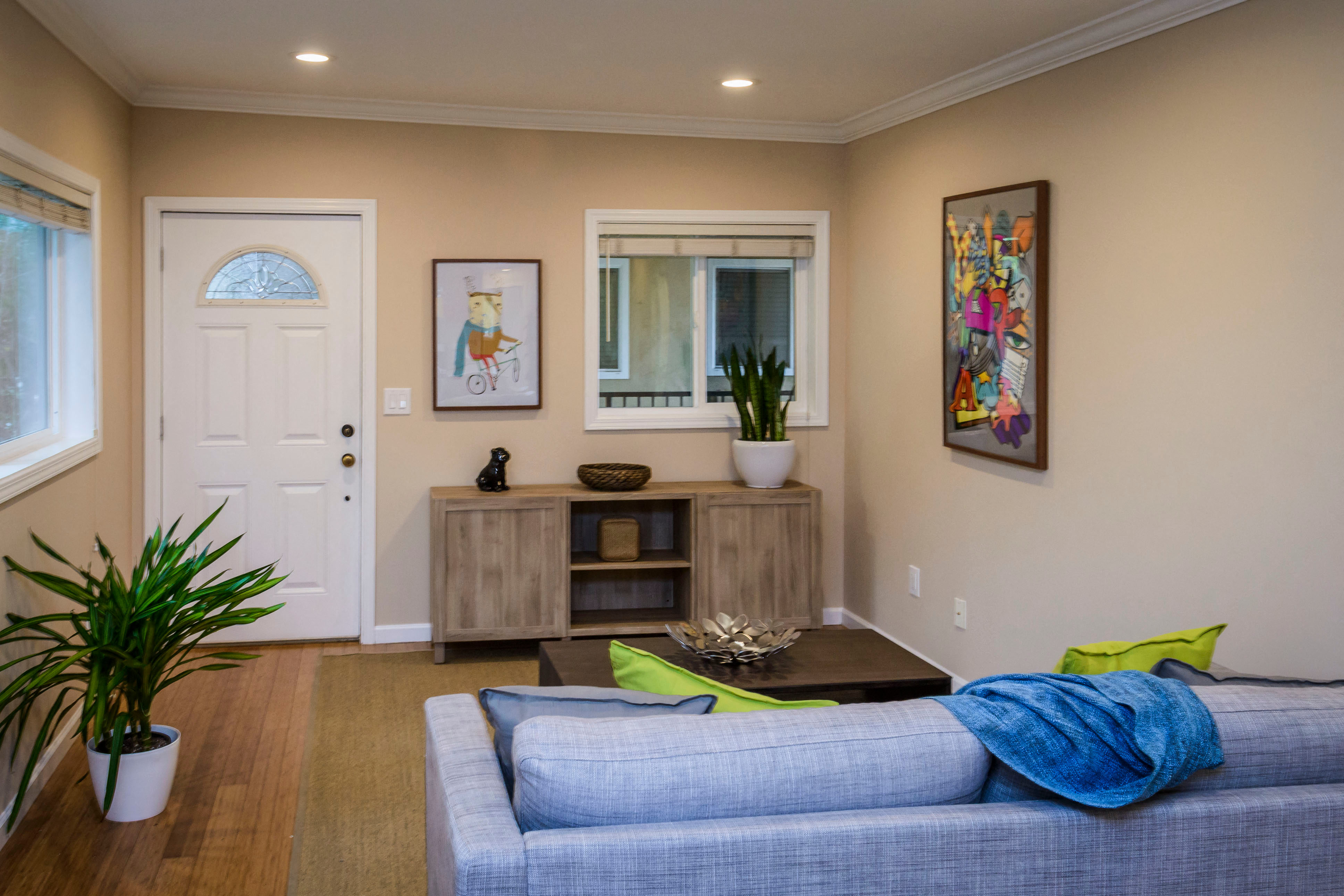 a living room with a blue couch and a coffee table