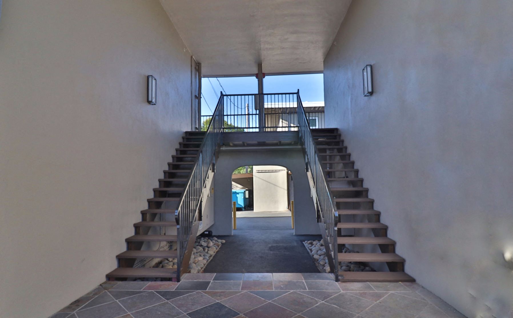 a set of stairs leading up to a house with a glass door