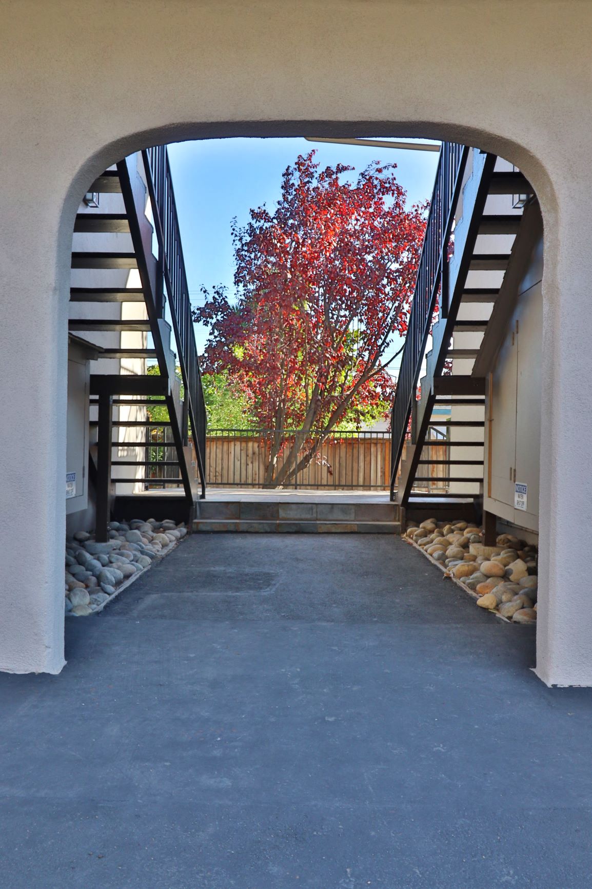 a view of a building with stairs and a tree
