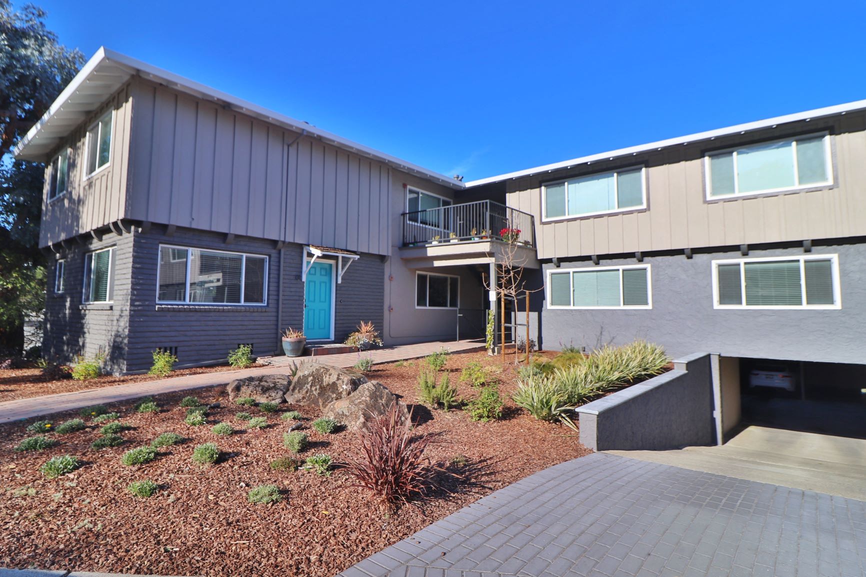 the front of a house with a patio and a walkway