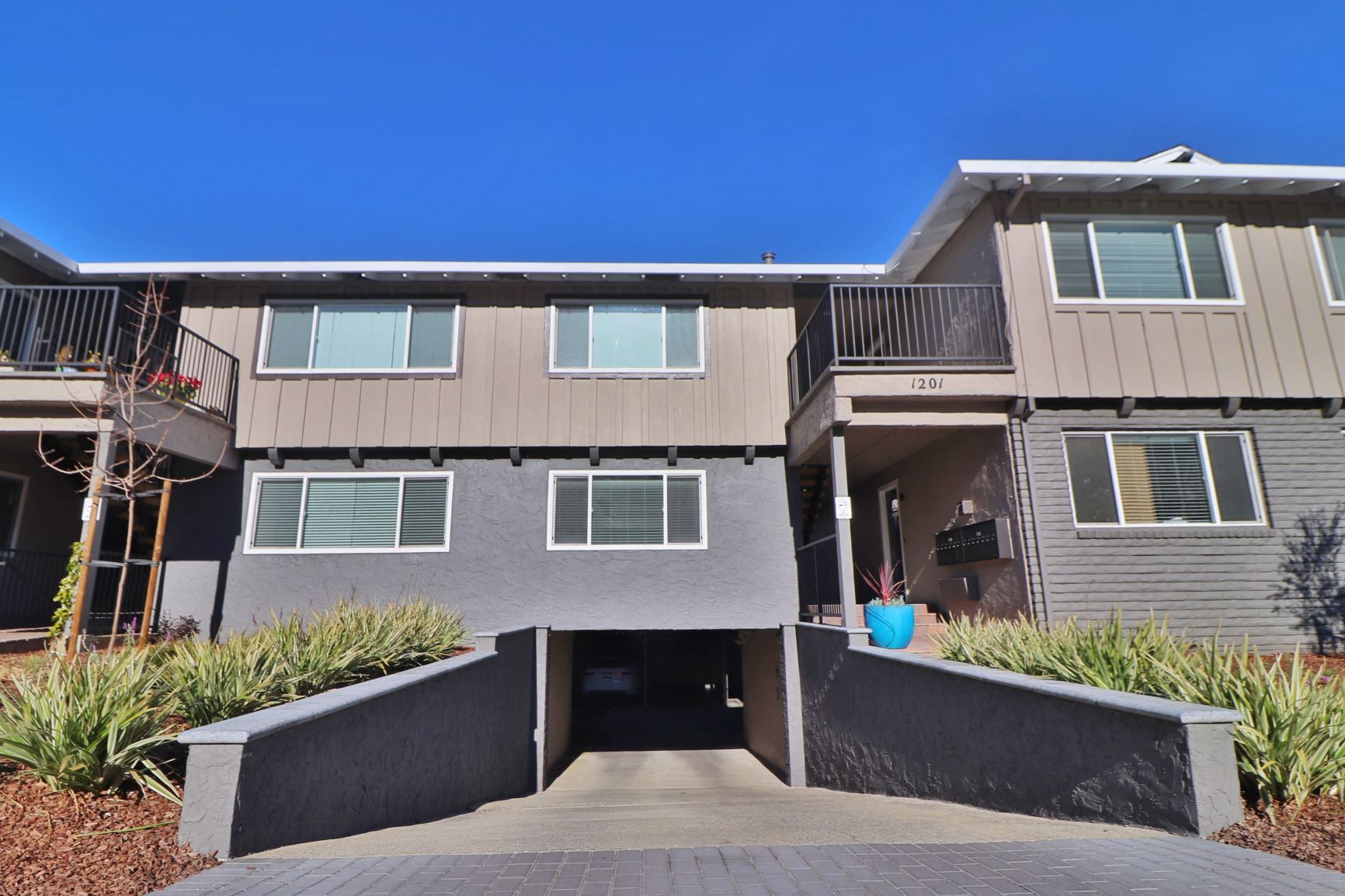 front view of an apartment building with a driveway