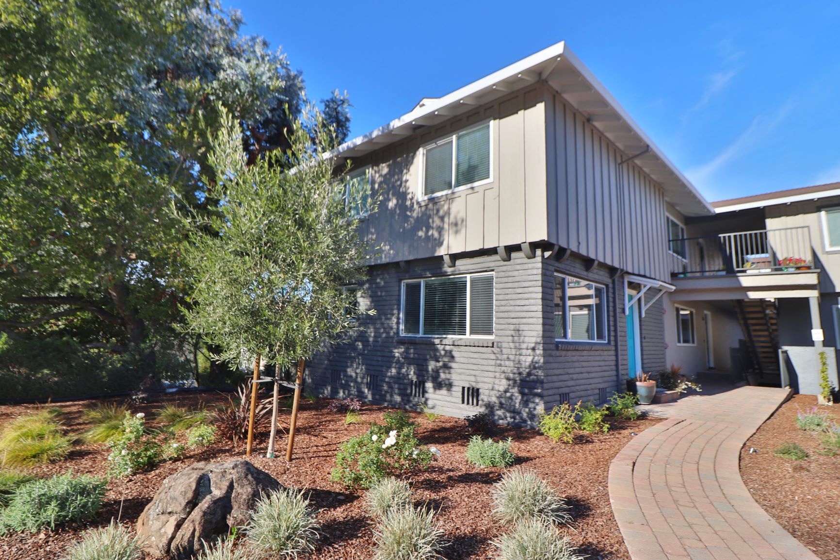 the exterior of a house with a walkway in front of it