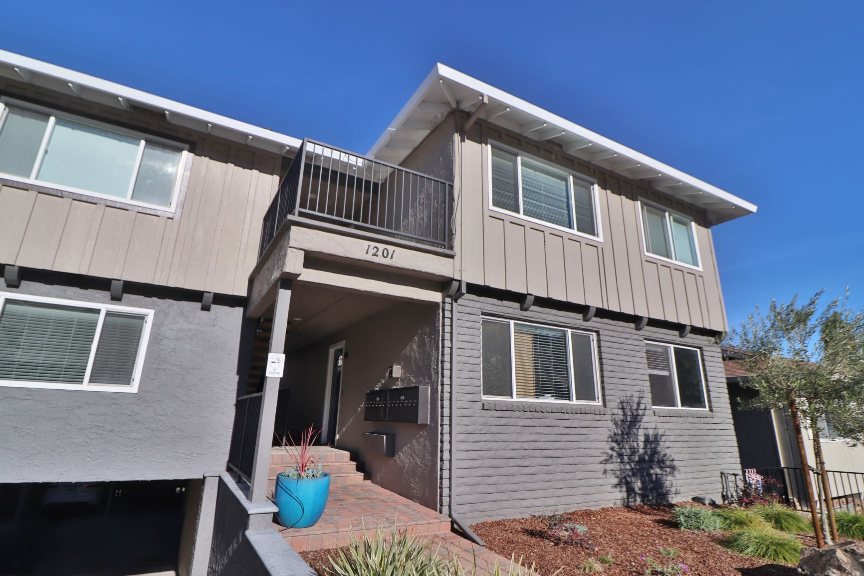 the exterior of a house with a porch and a balcony