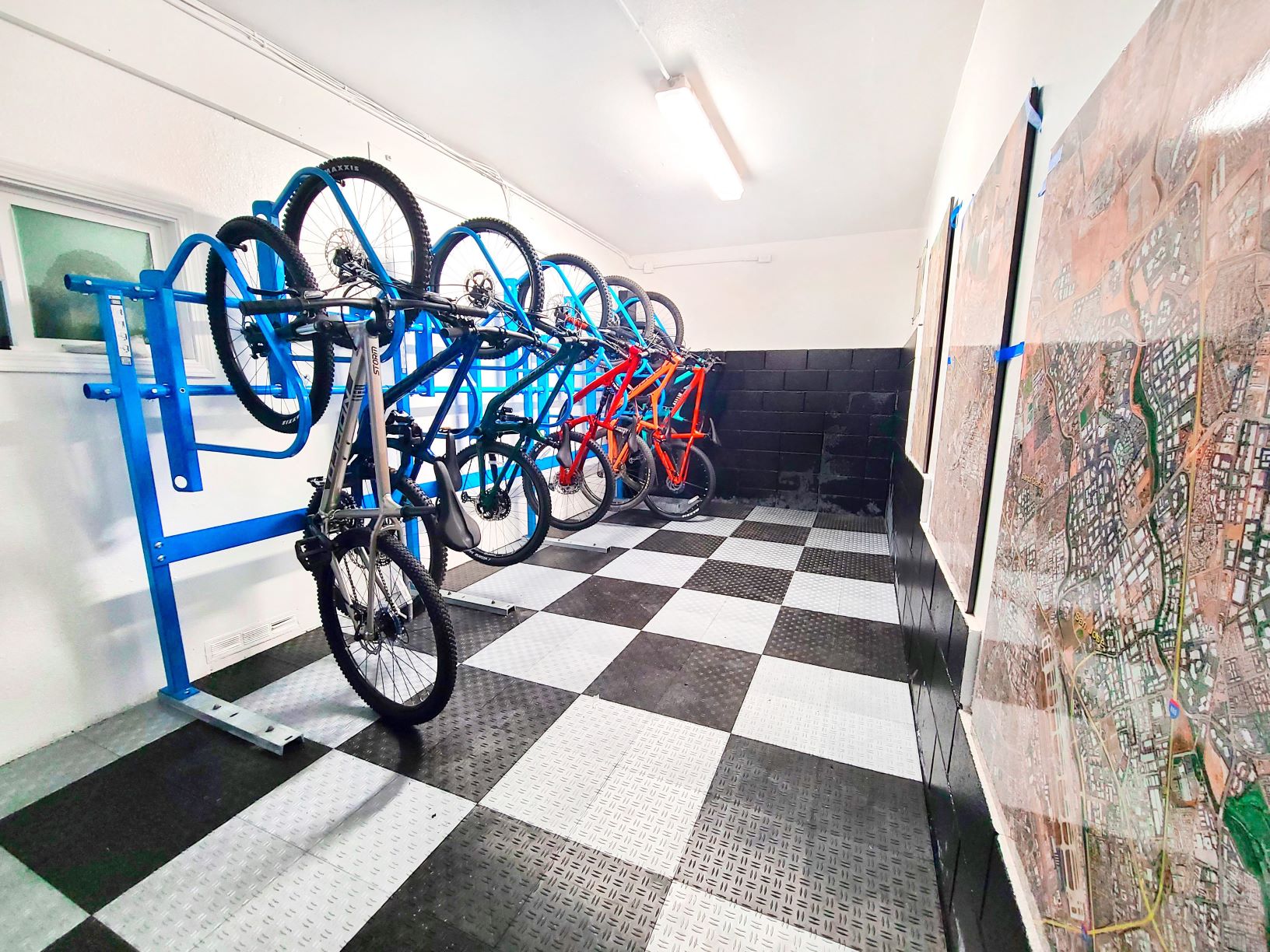 a row of bikes on a rack in a room