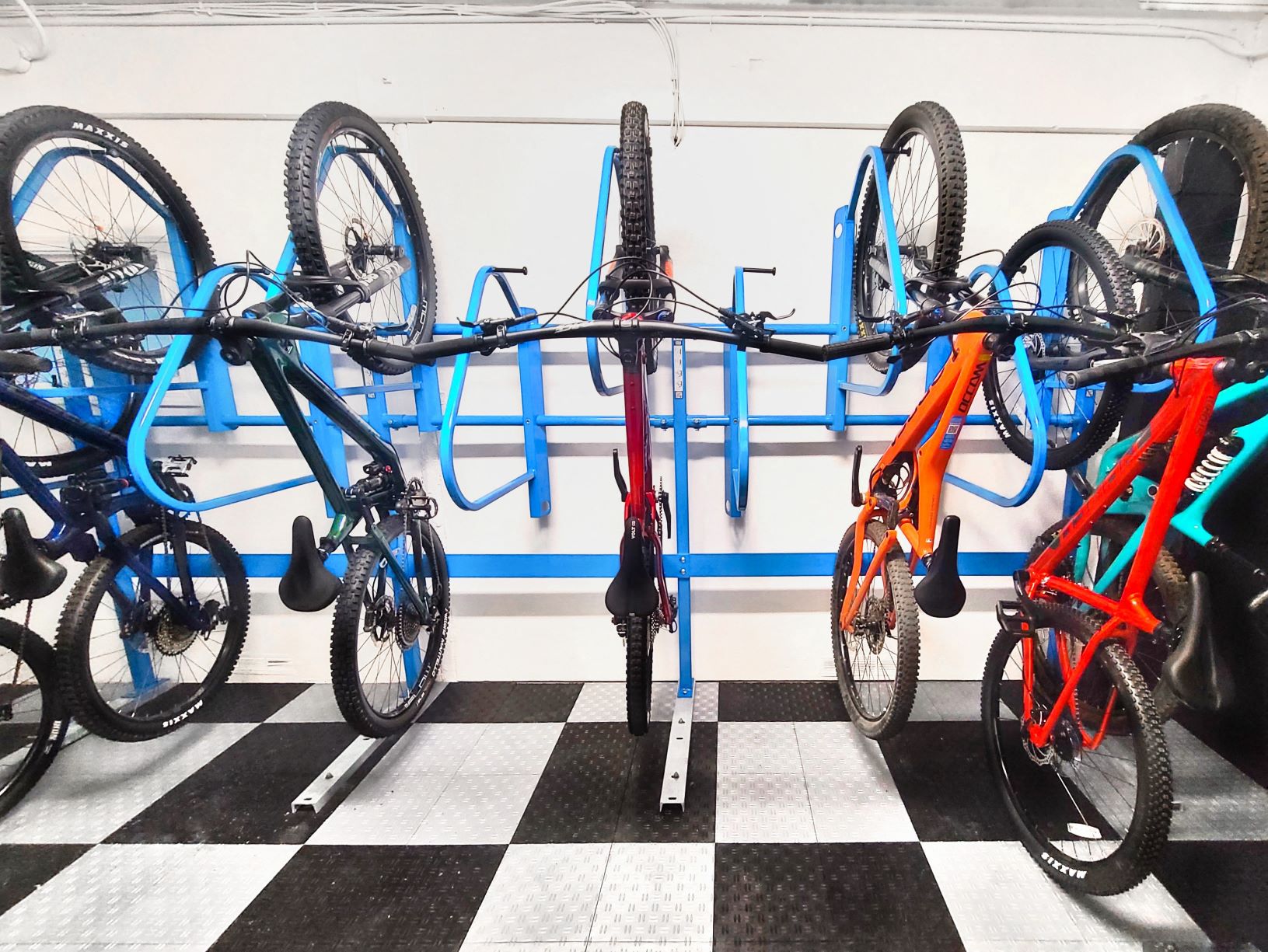 a row of bikes on racks in a store