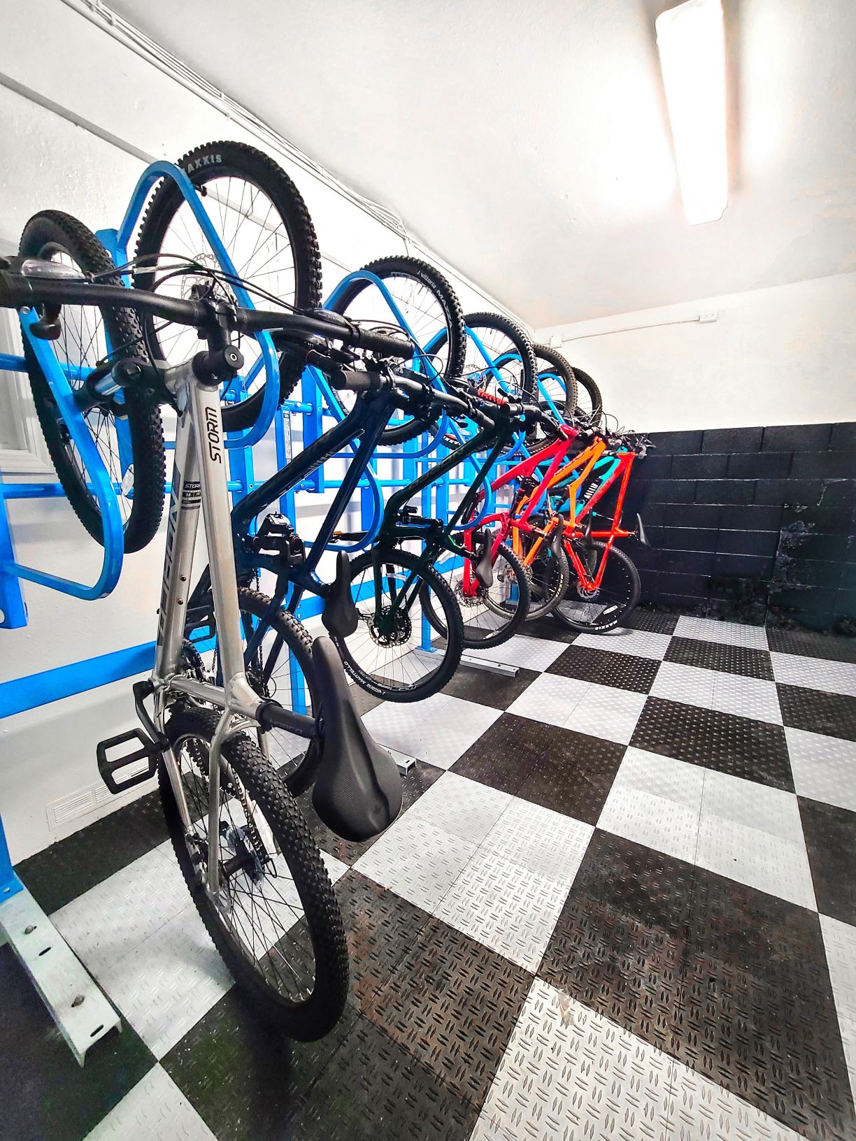 a row of bikes on a rack in a room