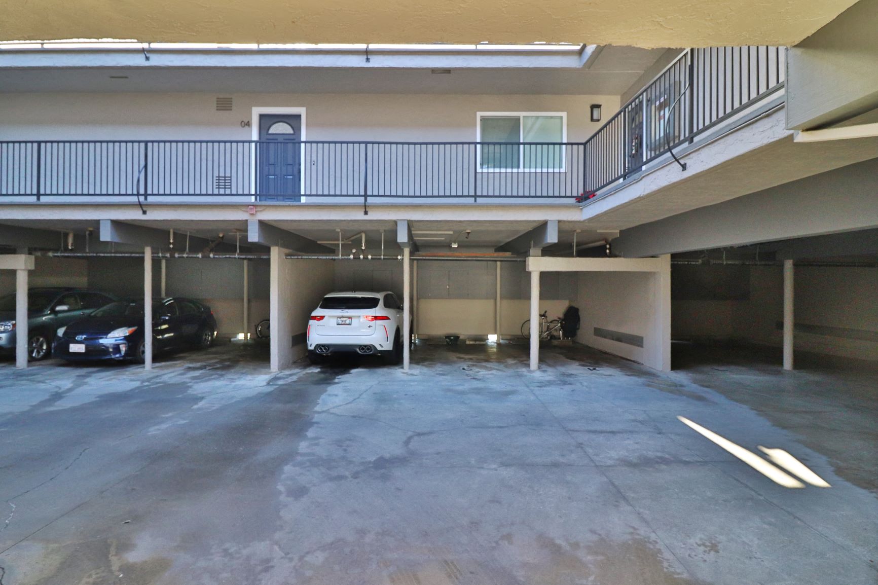 an empty parking garage with a white car in it
