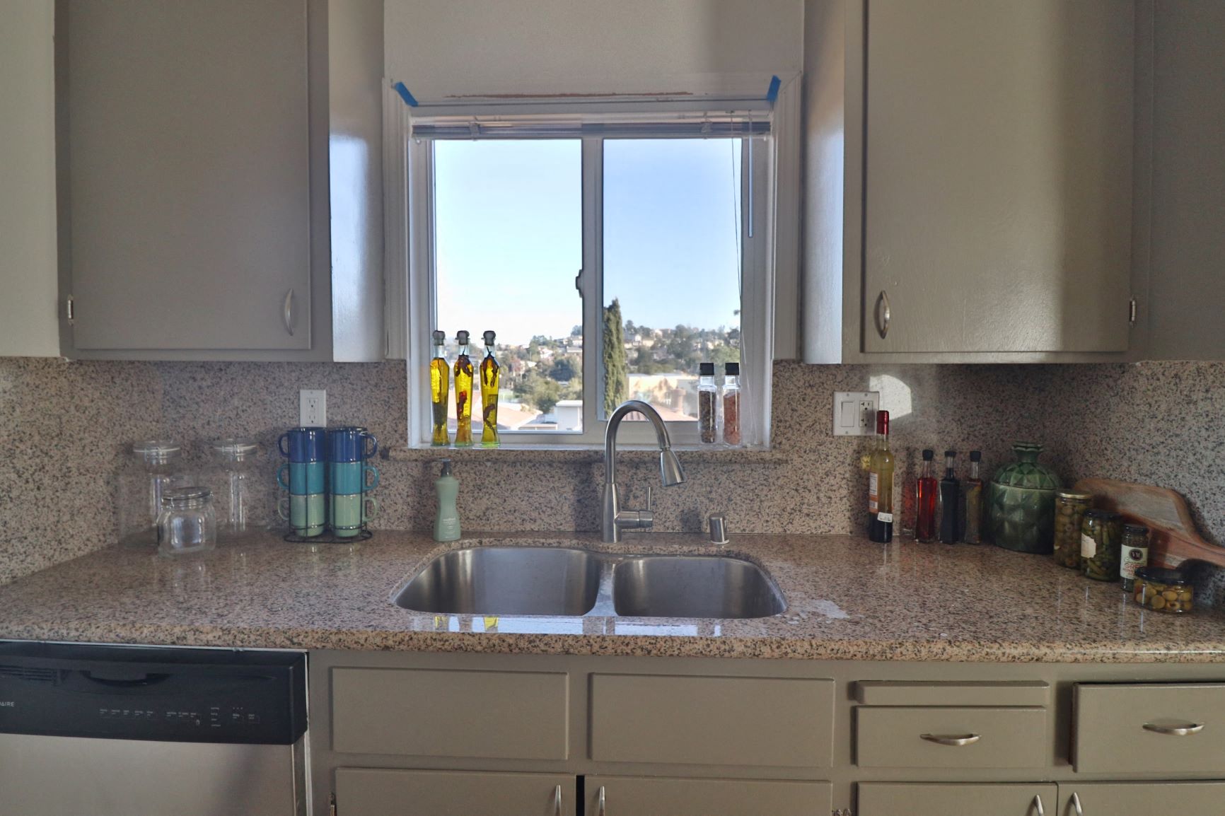 a kitchen counter with a sink and a window