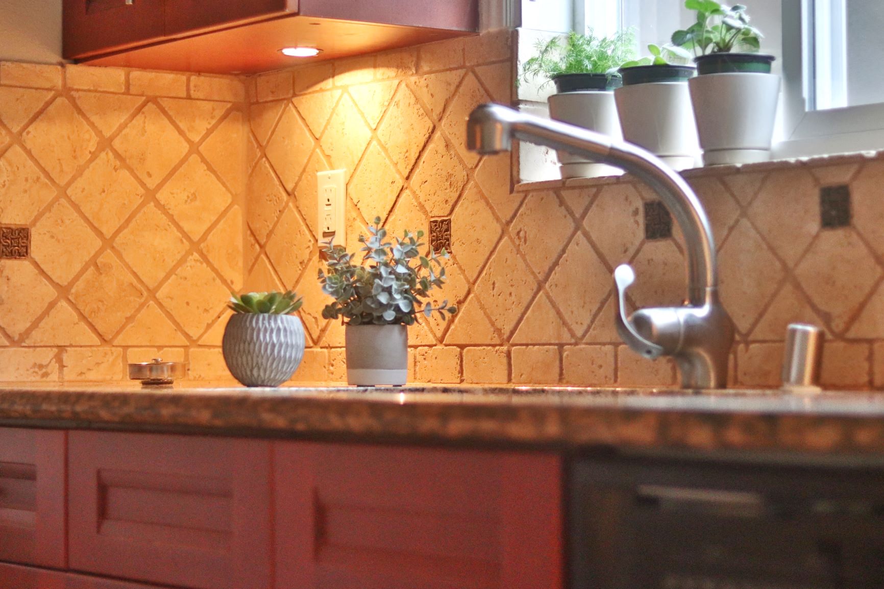 a kitchen counter with a sink and a faucet