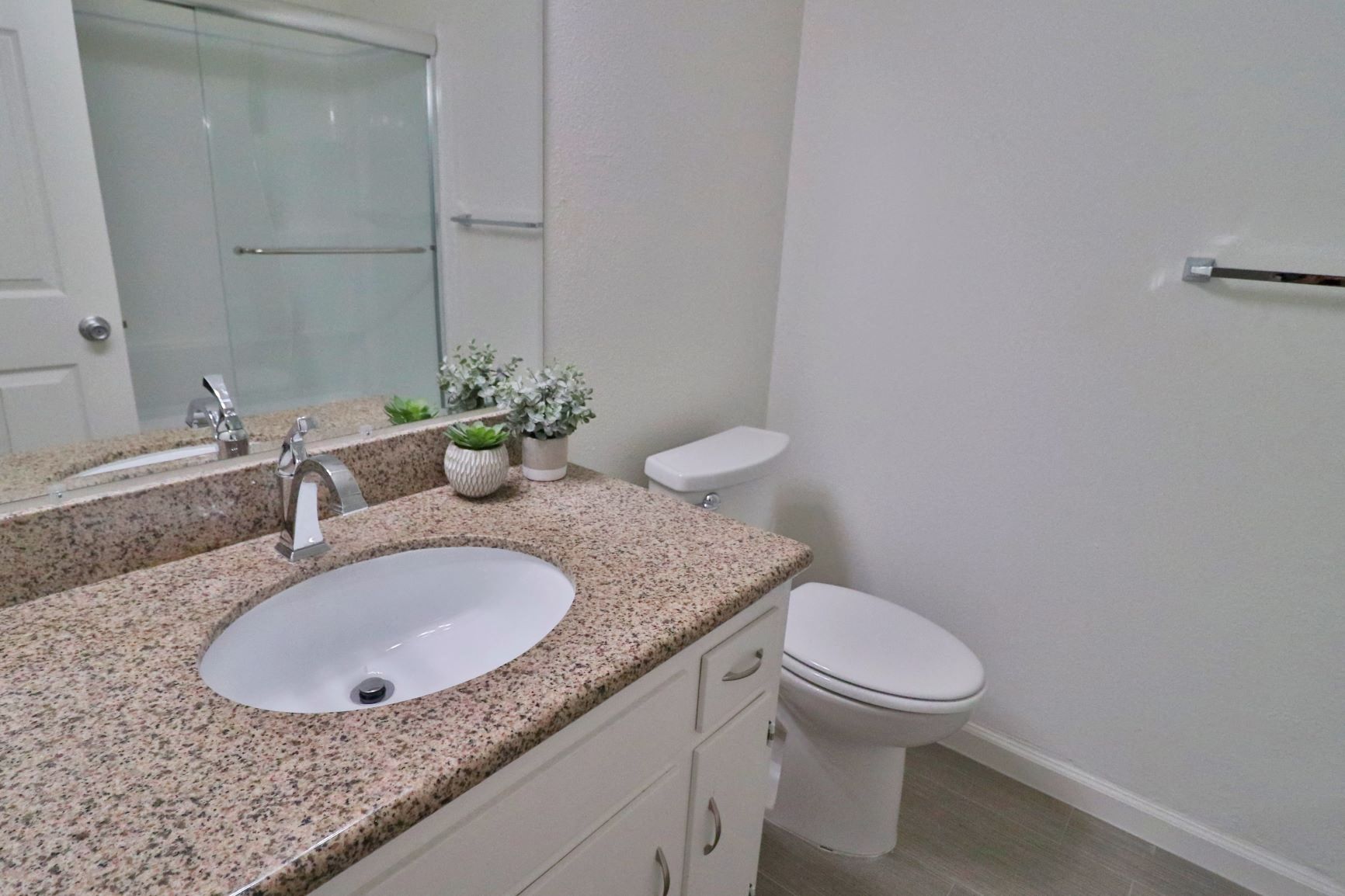 a bathroom with a sink and a toilet and a mirror