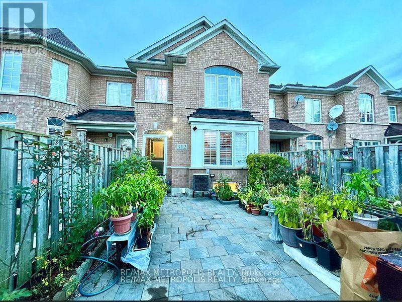 A brick house with a front yard and a bicycle.