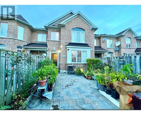 A brick house with a front yard and a bicycle.