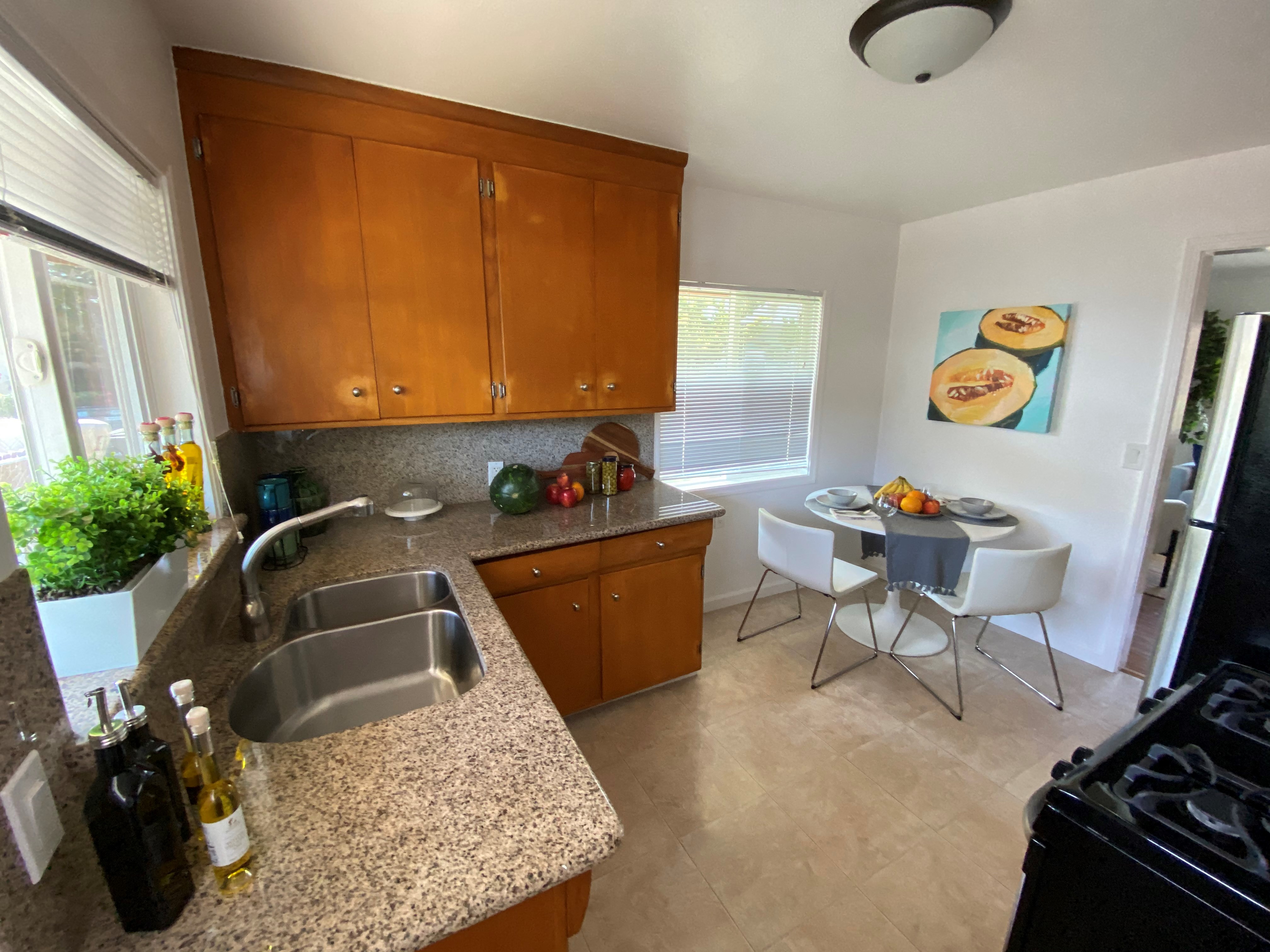 a kitchen with a sink and a table and chairs