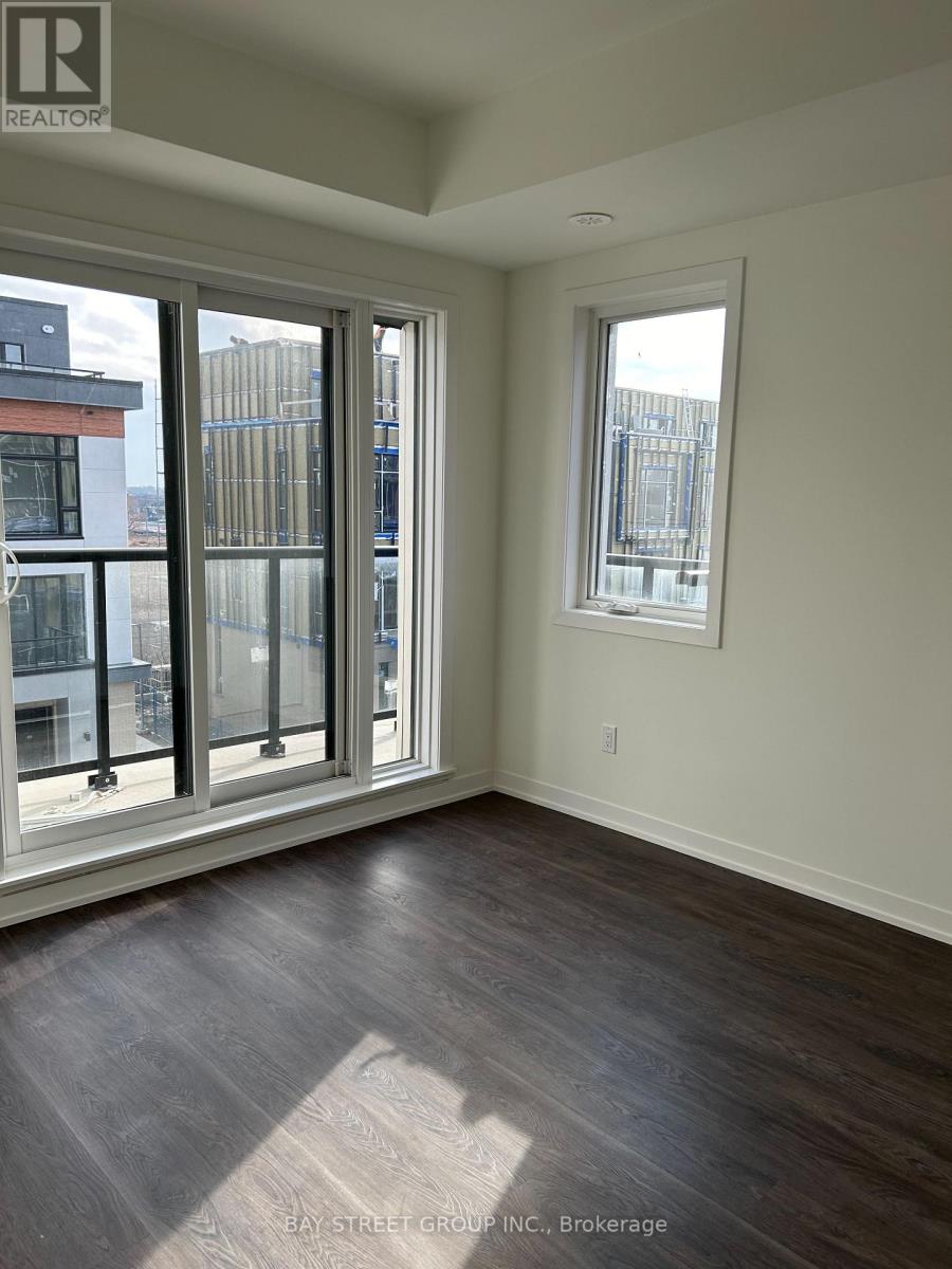 A room with a large window and a view of a city skyline.